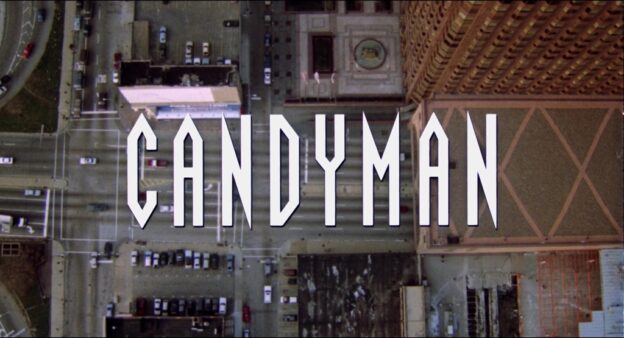 Title card for Candyman (1992), featuring bold white text over an aerial view of Chicago. The opening shot establishes the film’s urban setting and ominous tone.